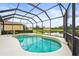 Inviting pool in a screened-in lanai overlooking a serene lake and manicured landscaping at 8118 Stirling Falls Cir, Sarasota, FL 34243