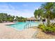 View of community pool with lush landscaping and palm trees at 8118 Stirling Falls Cir, Sarasota, FL 34243