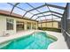 Inviting pool area in screened enclosure with tile roof home and manicured landscaping at 8118 Stirling Falls Cir, Sarasota, FL 34243