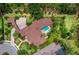 Aerial view showcasing the home, pool, lush landscaping, and surrounding neighborhood at 8316 Portlight Ct, Lakewood Ranch, FL 34202