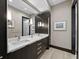 Bathroom with dual sinks, a large mirror, and modern fixtures at 8316 Portlight Ct, Lakewood Ranch, FL 34202