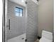 Modern bathroom with tiled shower and window at 8316 Portlight Ct, Lakewood Ranch, FL 34202