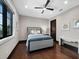 Comfortable bedroom with a window, ceiling fan, and dark wood floors at 8316 Portlight Ct, Lakewood Ranch, FL 34202