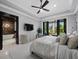 Bright main bedroom with tray ceiling, backyard view and decorative, stone wall bathroom entrance at 8316 Portlight Ct, Lakewood Ranch, FL 34202