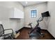 Home exercise room featuring a Peloton bike, mounted television and woven basket at 8316 Portlight Ct, Lakewood Ranch, FL 34202