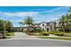 Lovely exterior home elevation showcasing lush landscaping, a circular driveway, and an arched entryway at 8316 Portlight Ct, Lakewood Ranch, FL 34202