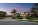 Stunning home with a circular driveway, arched entrances, manicured lawn, and vibrant flower beds, creating a picturesque estate at 8316 Portlight Ct, Lakewood Ranch, FL 34202