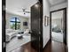 Hallway with entry into the living room featuring large windows and modern decor at 8316 Portlight Ct, Lakewood Ranch, FL 34202