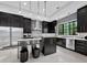 Modern kitchen features sleek cabinetry, stainless steel appliances, and an island with seating at 8316 Portlight Ct, Lakewood Ranch, FL 34202