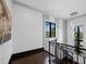 Well lit landing with dark wood floors, iron railing and window views at 8316 Portlight Ct, Lakewood Ranch, FL 34202