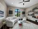 Bright living room featuring a curved sofa, modern shelving, and a large window at 8316 Portlight Ct, Lakewood Ranch, FL 34202
