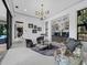 Bright living room with a custom bar, modern lighting, and elegant decor is ideal for entertaining guests at 8316 Portlight Ct, Lakewood Ranch, FL 34202
