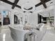 Elegant living room with modern furnishings, coffered ceiling, and striking chandelier at 8316 Portlight Ct, Lakewood Ranch, FL 34202