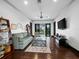 Spacious living room with dark wood floors, a ceiling fan, and sliding glass doors to the balcony at 8316 Portlight Ct, Lakewood Ranch, FL 34202