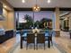 Outdoor dining area with a grill, a table with chairs and a view of the pool and landscaped backyard at 8316 Portlight Ct, Lakewood Ranch, FL 34202