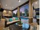 Covered patio featuring comfortable seating, an outdoor kitchen, and views of the sparkling pool and backyard at 8316 Portlight Ct, Lakewood Ranch, FL 34202