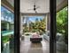 Covered outdoor living space with a fire pit, comfortable seating, and views of the lush backyard and pool at 8316 Portlight Ct, Lakewood Ranch, FL 34202