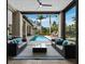 Covered patio with comfortable lounge seating and great view of the pool and backyard at 8316 Portlight Ct, Lakewood Ranch, FL 34202
