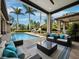 Covered patio featuring an outdoor seating area overlooking the backyard pool at 8316 Portlight Ct, Lakewood Ranch, FL 34202