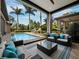 Covered patio featuring an outdoor seating area overlooking the backyard pool at 8316 Portlight Ct, Lakewood Ranch, FL 34202