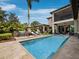 Gorgeous pool area with sun loungers, rock waterfall feature, and lush landscaping at 8316 Portlight Ct, Lakewood Ranch, FL 34202