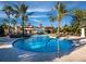 Community pool with palm trees and comfortable lounge chairs under a bright, sunny sky at 8316 Portlight Ct, Lakewood Ranch, FL 34202