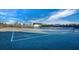 Outdoor tennis court with a covered bench providing a shaded area for players at 8316 Portlight Ct, Lakewood Ranch, FL 34202