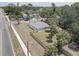 A well-kept backyard with a new wooden fence, palm trees, and lush greenery surrounding this single-story home at 904 Winter Garden Dr, Sarasota, FL 34243