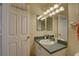 Bathroom featuring a sink with a green countertop and a white door with a coat rack at 904 Winter Garden Dr, Sarasota, FL 34243