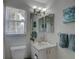 Bathroom featuring a bright window, a white toilet, and blue decor at 904 Winter Garden Dr, Sarasota, FL 34243
