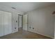 Clean bedroom with a closet and a view into the hallway at 904 Winter Garden Dr, Sarasota, FL 34243