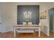 Cozy dining area featuring a modern chandelier, custom wall accents, and ample natural light at 904 Winter Garden Dr, Sarasota, FL 34243