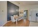 Elegant dining room with stylish chandelier, decorative wall panel, and convenient access to kitchen and bathroom at 904 Winter Garden Dr, Sarasota, FL 34243