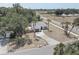Quaint single-story home boasting a gray roof, long driveway, and lovely landscaping with palm tree accents at 904 Winter Garden Dr, Sarasota, FL 34243