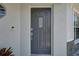 Close up of the front door with a smart lock and ring doorbell, accented by stone-veneer siding at 904 Winter Garden Dr, Sarasota, FL 34243