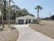 Charming home featuring a well-manicured lawn, updated driveway, and a two-car garage at 904 Winter Garden Dr, Sarasota, FL 34243