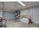 Spacious garage with gray door, shelving, and ample storage space for vehicles and tools at 904 Winter Garden Dr, Sarasota, FL 34243