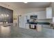 Open kitchen featuring modern appliances, white cabinetry, and seamless flow into the dining area at 904 Winter Garden Dr, Sarasota, FL 34243