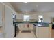 Well-lit kitchen with stainless steel appliances, white cabinets, and convenient counter space for meal preparation at 904 Winter Garden Dr, Sarasota, FL 34243