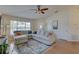 Cozy living area showcasing a sectional sofa, hardwood floors, and a ceiling fan for added comfort at 904 Winter Garden Dr, Sarasota, FL 34243