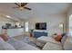 Open-concept living area featuring a sectional sofa, hardwood floors, and seamless access to the kitchen at 904 Winter Garden Dr, Sarasota, FL 34243
