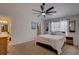 Inviting main bedroom with large window, ceiling fan, and en-suite bathroom for added convenience at 904 Winter Garden Dr, Sarasota, FL 34243