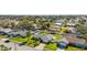 Aerial view of a well-maintained property with a green lawn and a white fence in a suburban neighborhood at 913 64Th W St, Bradenton, FL 34209