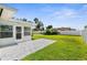 Inviting outdoor space with a covered patio, lush lawn, and well maintained garden at 913 64Th W St, Bradenton, FL 34209