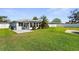 Lush green backyard with beautiful landscaping and a screened patio at 913 64Th W St, Bradenton, FL 34209