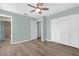 Light and airy bedroom with wood-look flooring and modern ceiling fan at 913 64Th W St, Bradenton, FL 34209