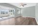 Comfortable room with sliding glass doors to the sunroom, ample natural light, and modern vinyl flooring at 913 64Th W St, Bradenton, FL 34209