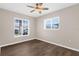 Cozy bedroom featuring warm neutral paint and two windows that provide natural light at 913 64Th W St, Bradenton, FL 34209
