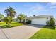 Charming single-story home with a manicured lawn and mature palm trees at 913 64Th W St, Bradenton, FL 34209