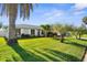 Charming home with tropical landscaping including mature palm trees and a well-maintained lawn at 913 64Th W St, Bradenton, FL 34209